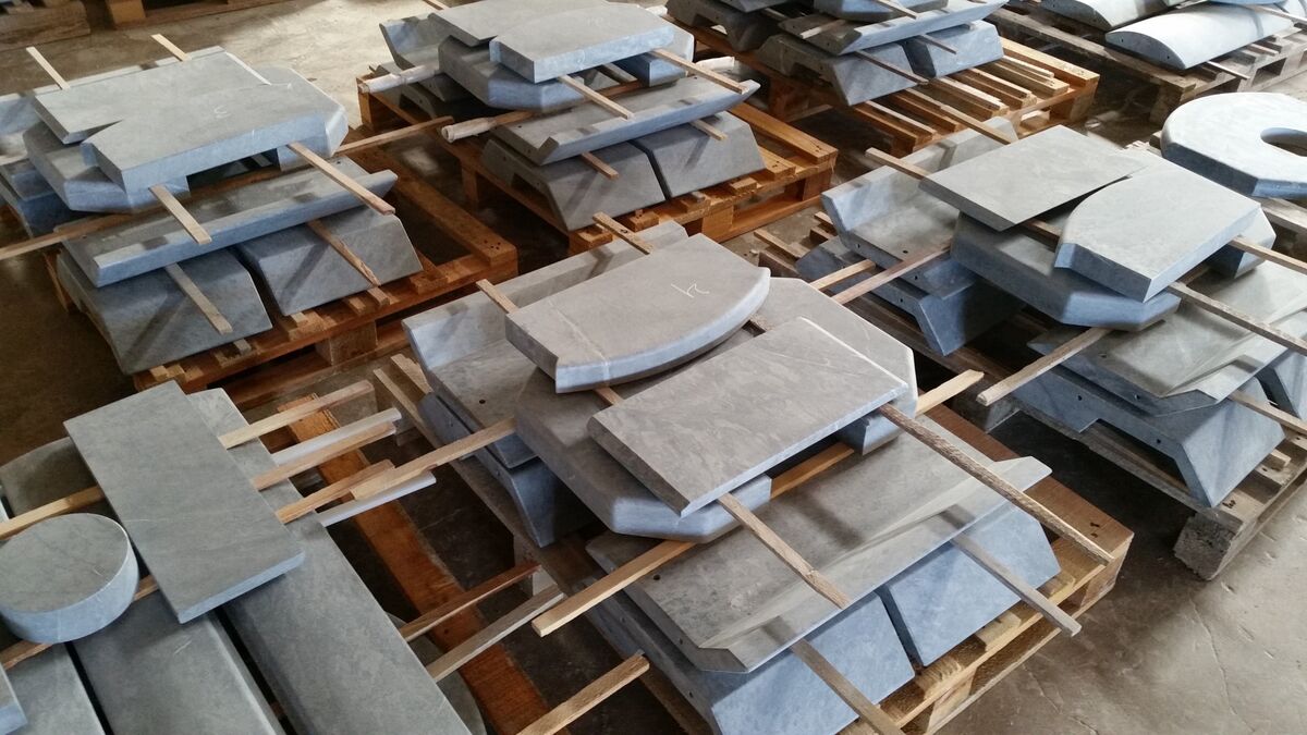 Finished soapstone parts for stoves on pallets
