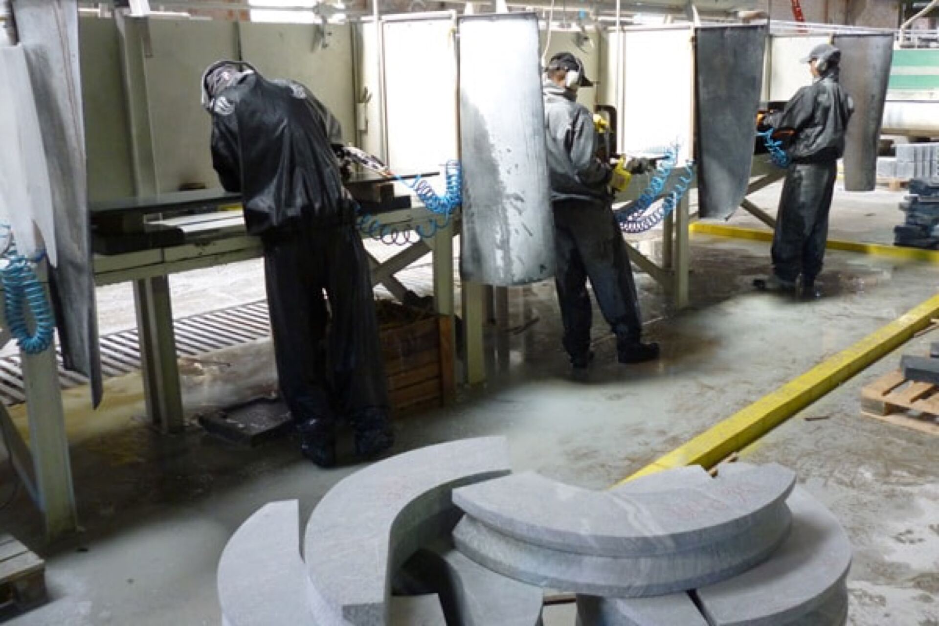 Employees finishing soapstone parts
